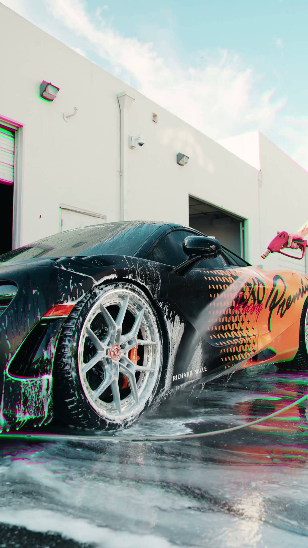 White McLaren covered in wash foam outside the Collective Detailing studio bay in Irvine